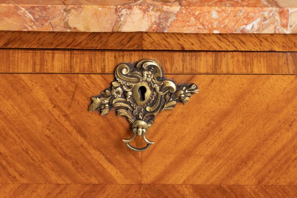 A matching pair of French 19th-century walnut and kingwood bedside cabinets featuring pink marble tops, parquetry drawer fronts, cabriole legs, and ornate brass mounts. View III