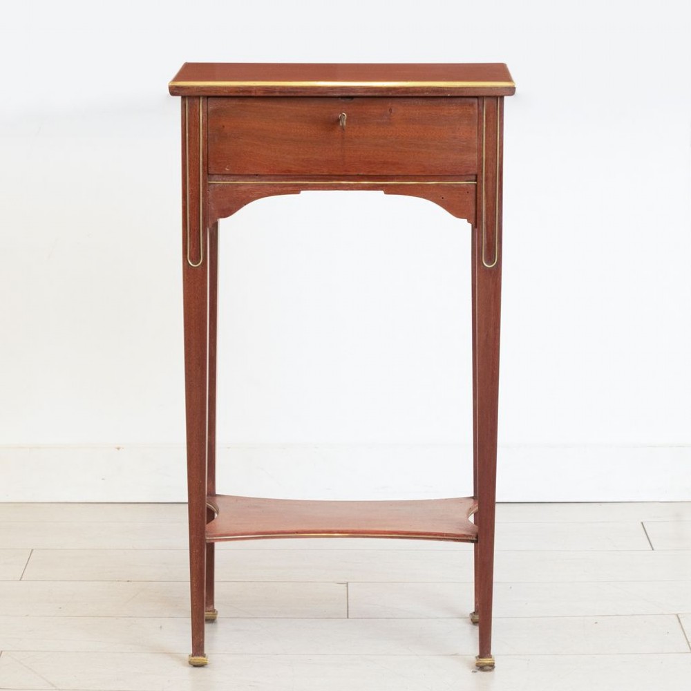 A tall French mahogany bedside table featuring a single drawer with brass stringing inlay, tapered legs, lower shelf, and brass feet. View II