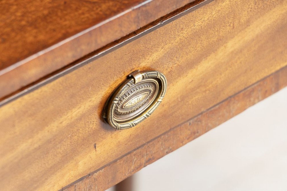 A 19th-century mahogany writing table featuring three frieze drawers with oval brass handles and four slender turned legs. View III