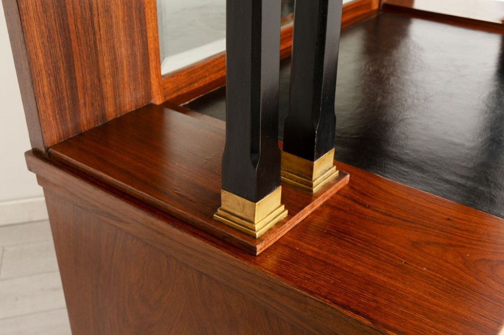 An antique Viennese Secessionist walnut display cabinet featuring geometric marquetry inlays, ebonised column supports, upper glazed doors, a central mirrored niche, and a lower two-door cupboard. View VI