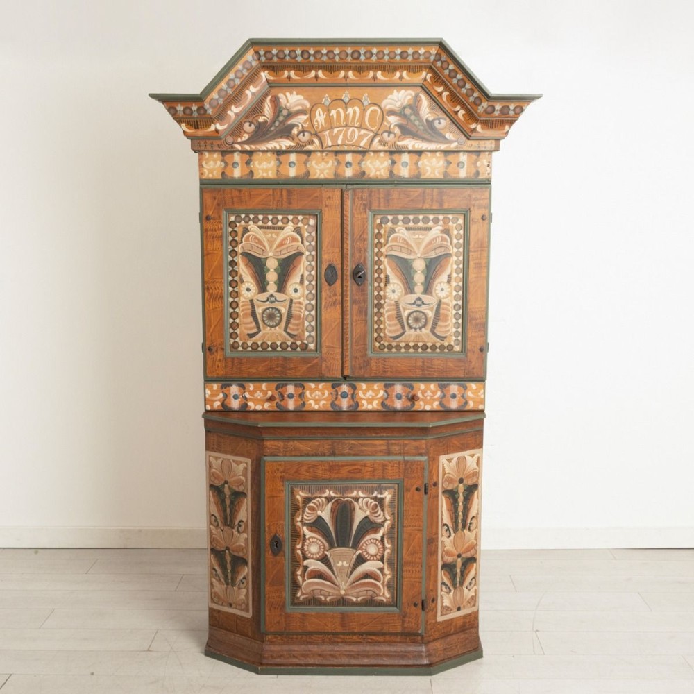 An eighteenth-century Swedish painted timber cupboard featuring two upper doors, a lower door, and decorative floral and geometric panels dated 1797.