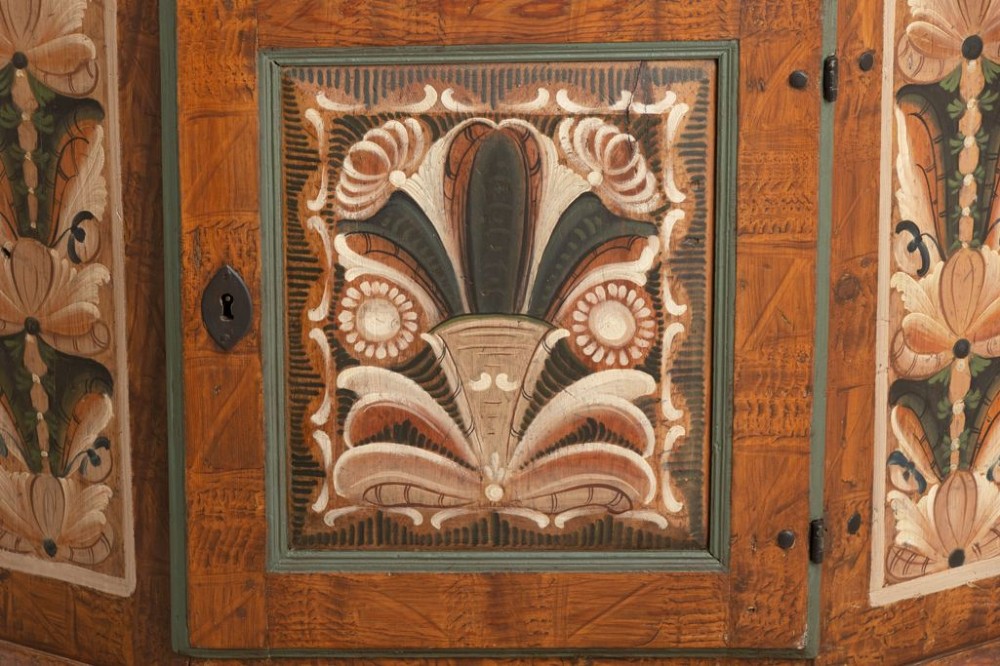 An eighteenth-century Swedish painted timber cupboard featuring two upper doors, a lower door, and decorative floral and geometric panels dated 1797. View IV