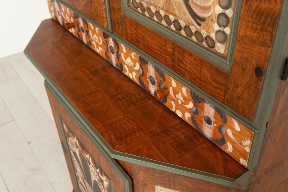 An eighteenth-century Swedish painted timber cupboard featuring two upper doors, a lower door, and decorative floral and geometric panels dated 1797. View V