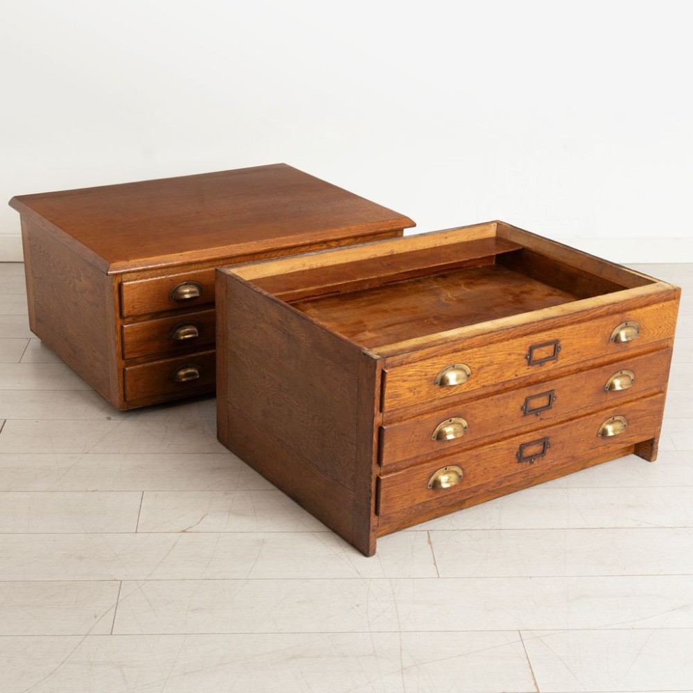 An antique golden oak plan chest featuring six wide shallow drawers arranged in two stacking sections with brass cup handles and central card index holders. View III