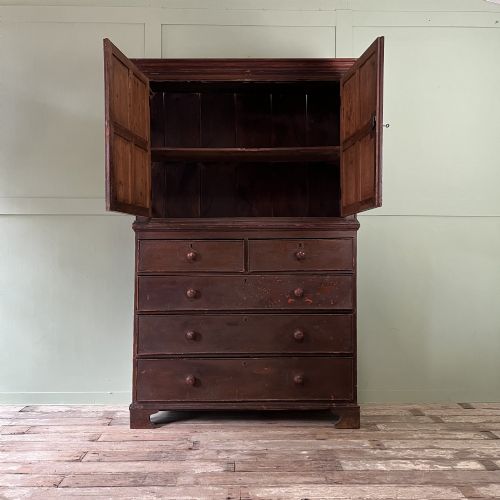 fig 1. An early 19th-century Irish painted pine press cupboard with two panelled upper doors over a base section containing five drawers.
