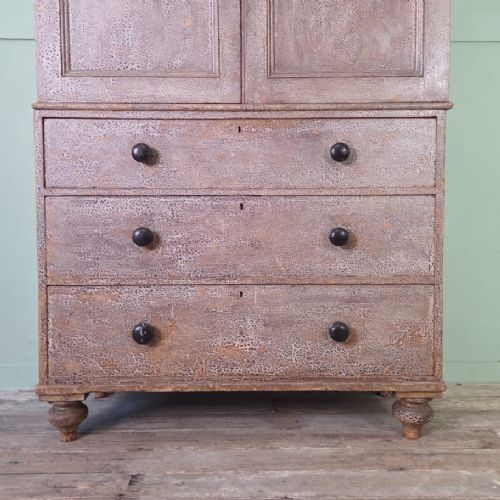 A tall late Georgian painted pine housekeepers cupboard featuring panelled upper doors and three lower drawers on turned feet. View X