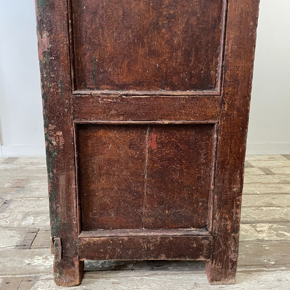 A late 18th-century dark brown painted pine food cupboard with arched mesh upper doors and fielded panel lower doors. View XIV
