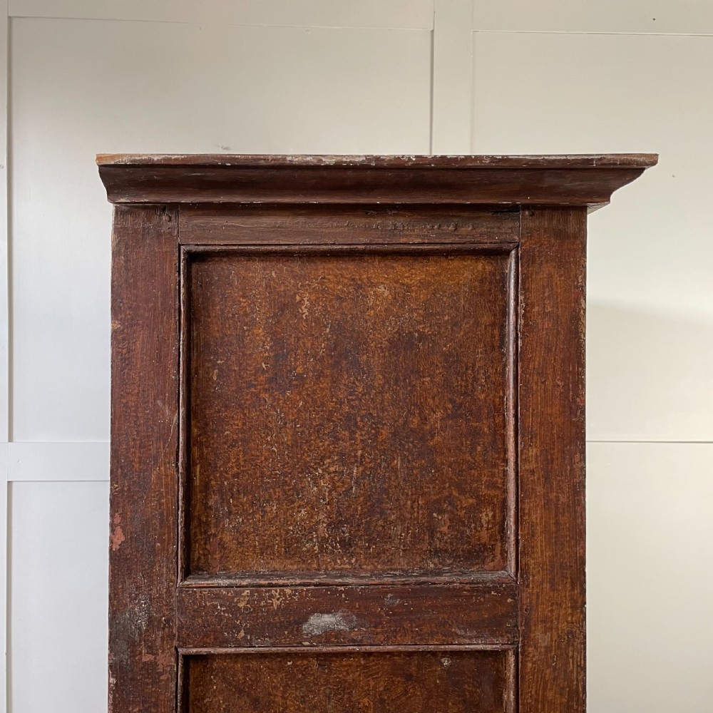 A late 18th-century dark brown painted pine food cupboard with arched mesh upper doors and fielded panel lower doors. View XV