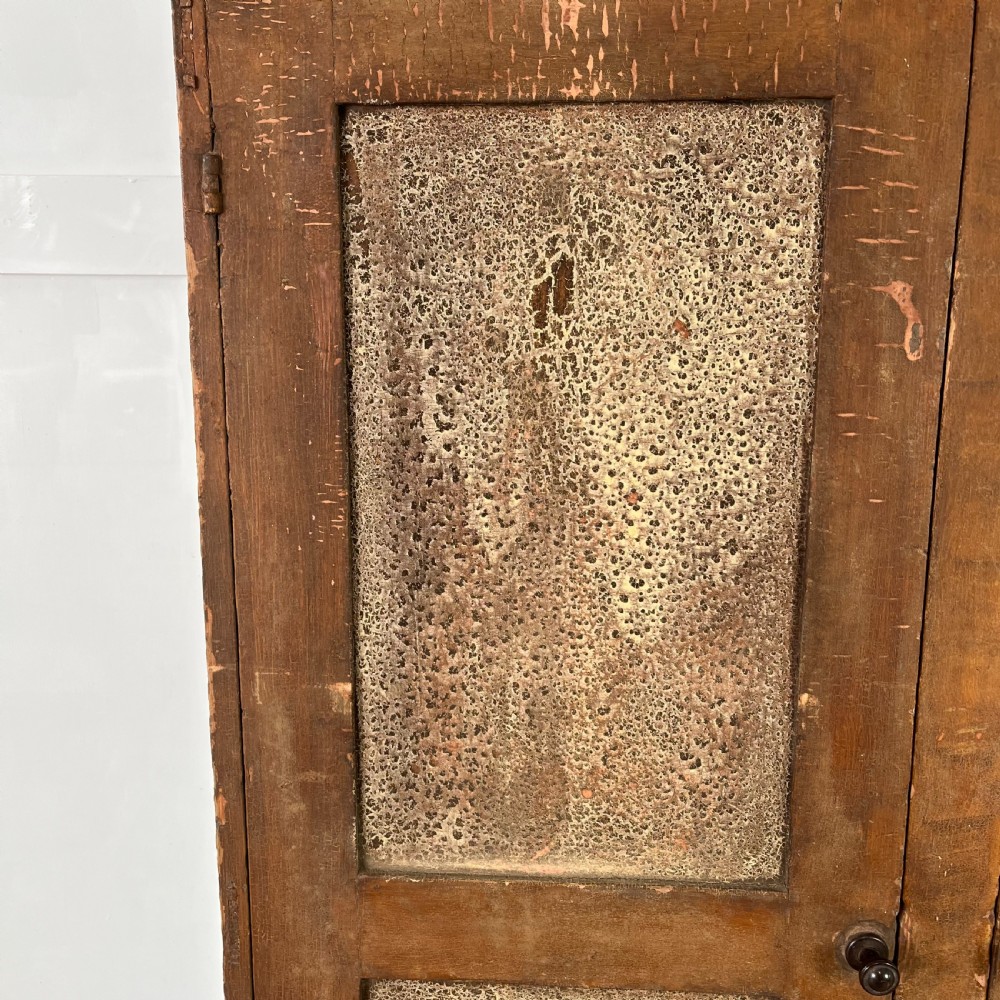 A nineteenth-century two-door pine cupboard featuring distressed crackle-glaze panel doors and a shaped cresting rail. View IV