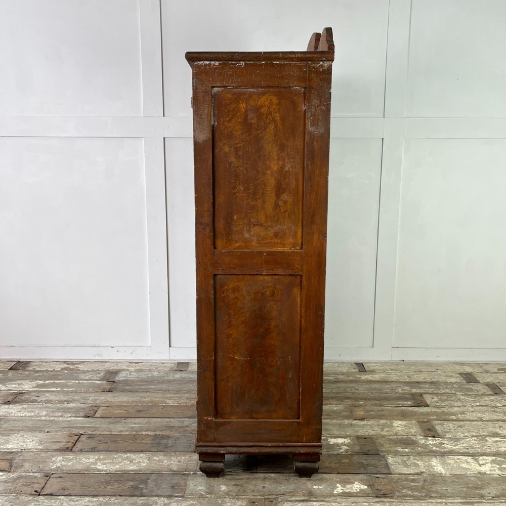 A nineteenth-century two-door pine cupboard featuring distressed crackle-glaze panel doors and a shaped cresting rail. View IX