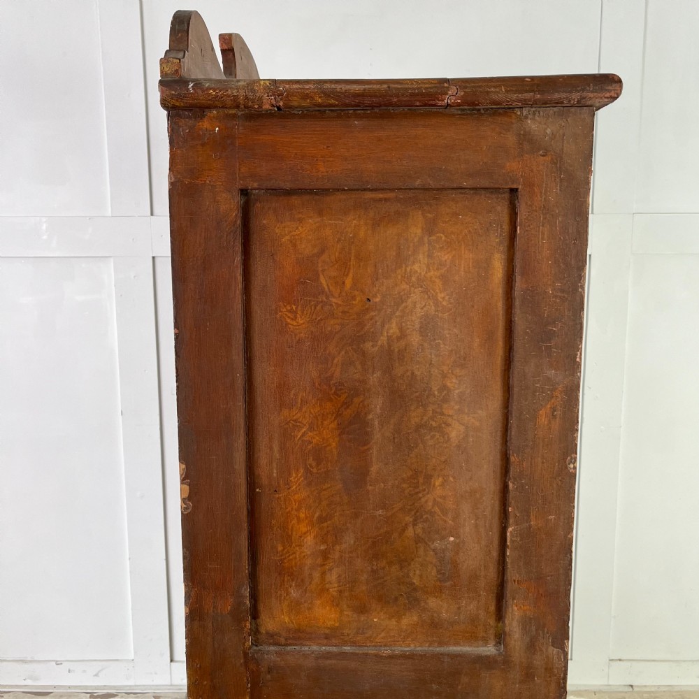 A nineteenth-century two-door pine cupboard featuring distressed crackle-glaze panel doors and a shaped cresting rail. View XII