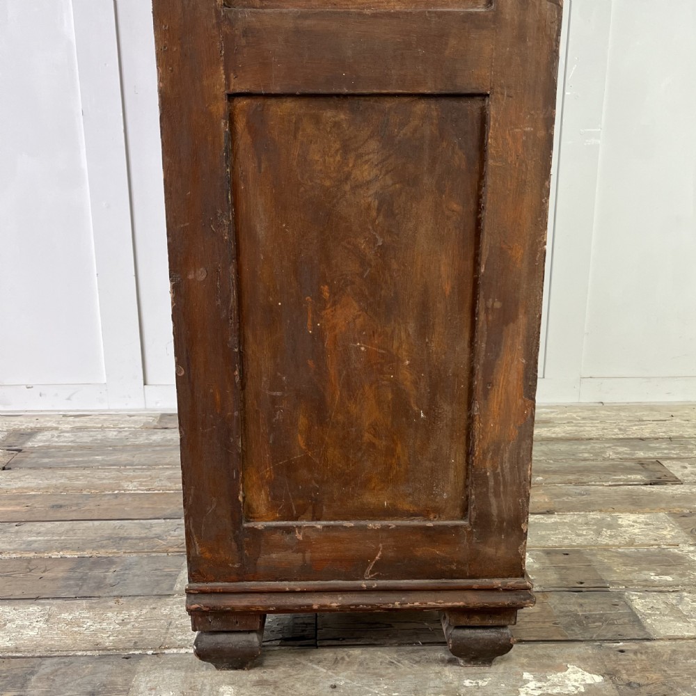 A nineteenth-century two-door pine cupboard featuring distressed crackle-glaze panel doors and a shaped cresting rail. View XIII