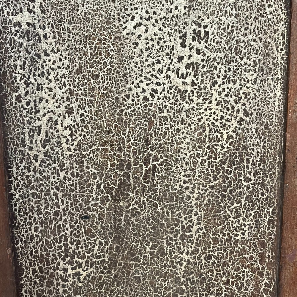 A nineteenth-century two-door pine cupboard featuring distressed crackle-glaze panel doors and a shaped cresting rail. View XV