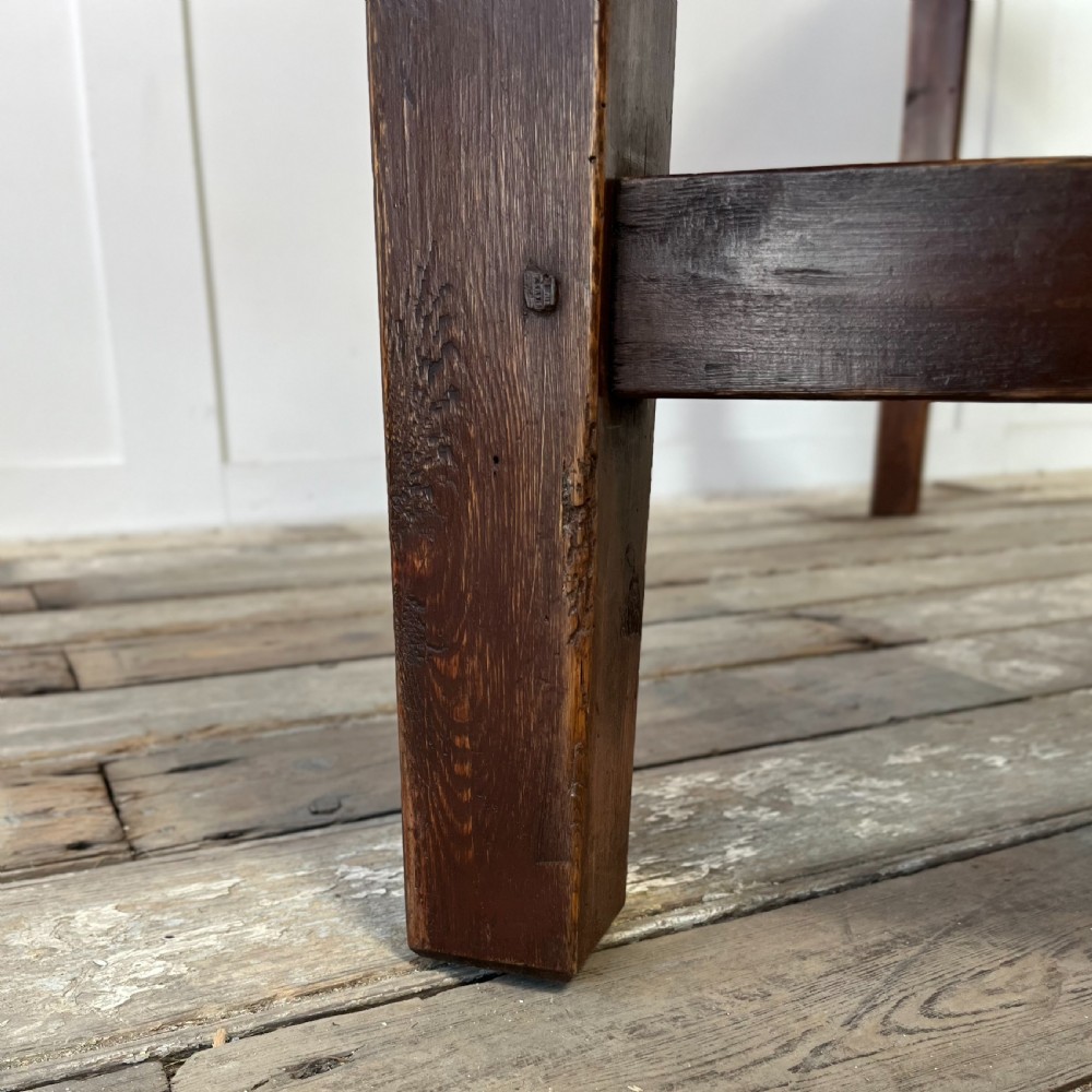 A 19th-century Welsh pine kitchen table featuring a light wood plank top supported by a dark stained wooden frame with square legs and a low stretcher. View VIII