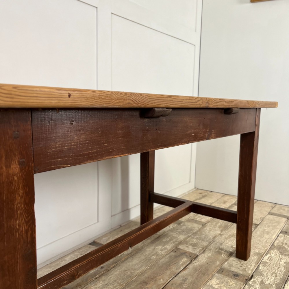 A 19th-century Welsh pine kitchen table featuring a light wood plank top supported by a dark stained wooden frame with square legs and a low stretcher. View XI