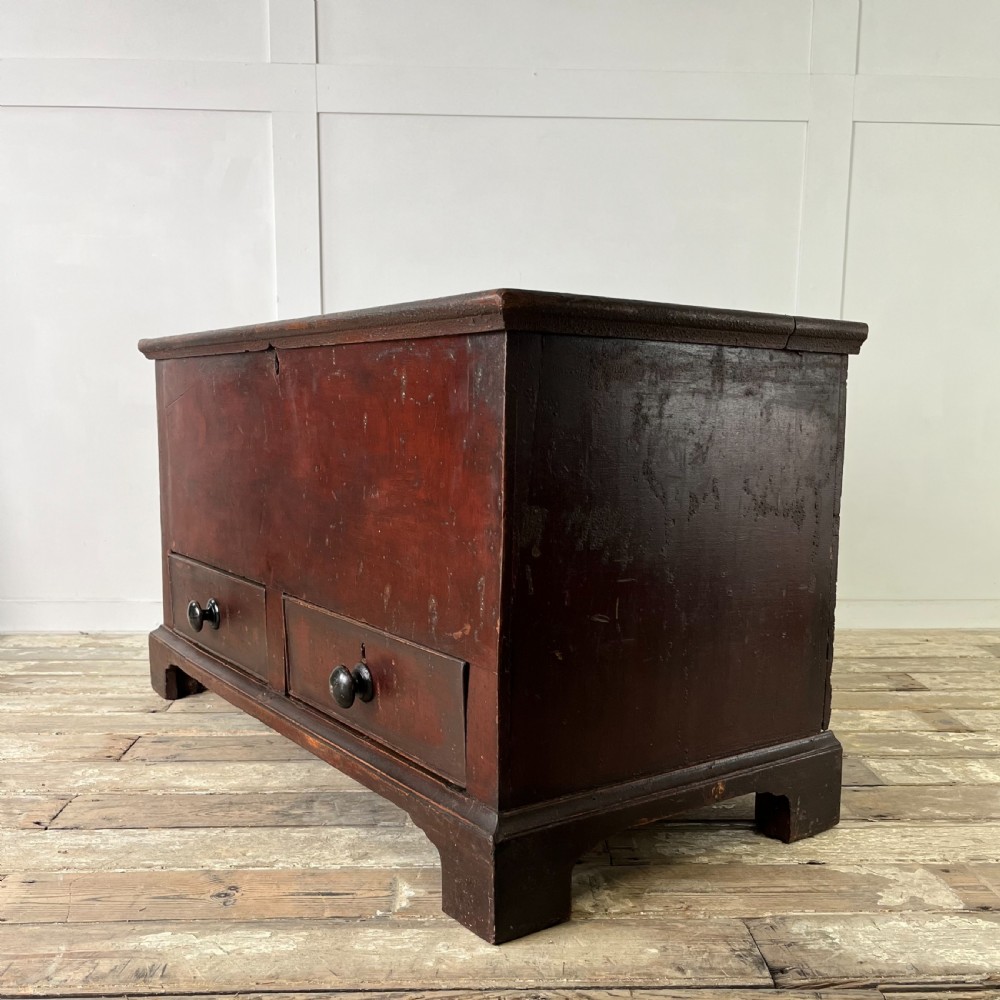 A dark red painted Georgian pine mule chest featuring a hinged top lid above two lower drawers with turned wooden knobs. View XII