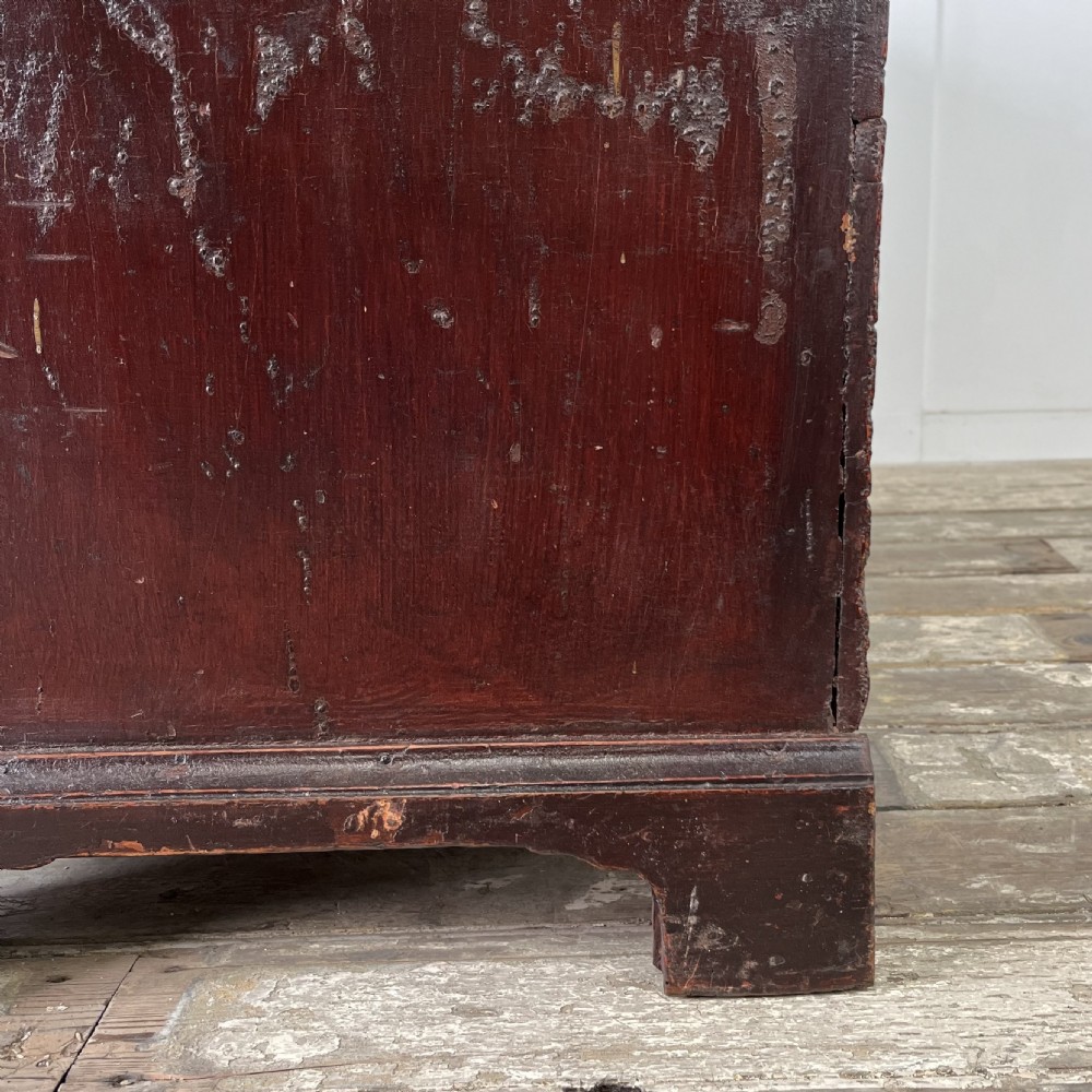 A dark red painted Georgian pine mule chest featuring a hinged top lid above two lower drawers with turned wooden knobs. View XIV