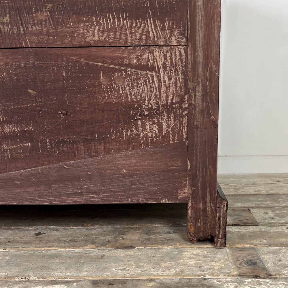 A dark red painted Georgian pine mule chest featuring a hinged top lid above two lower drawers with turned wooden knobs. View XVI