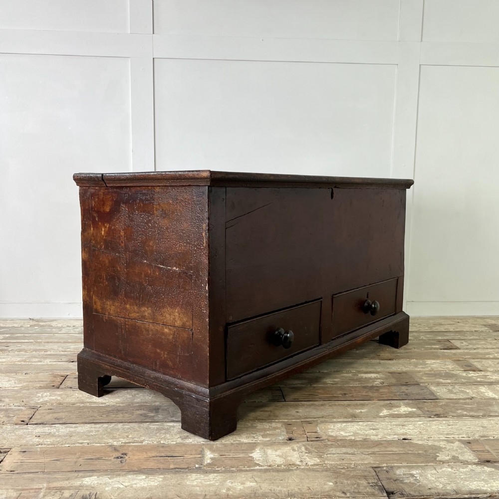 A dark red painted Georgian pine mule chest featuring a hinged top lid above two lower drawers with turned wooden knobs. View XX
