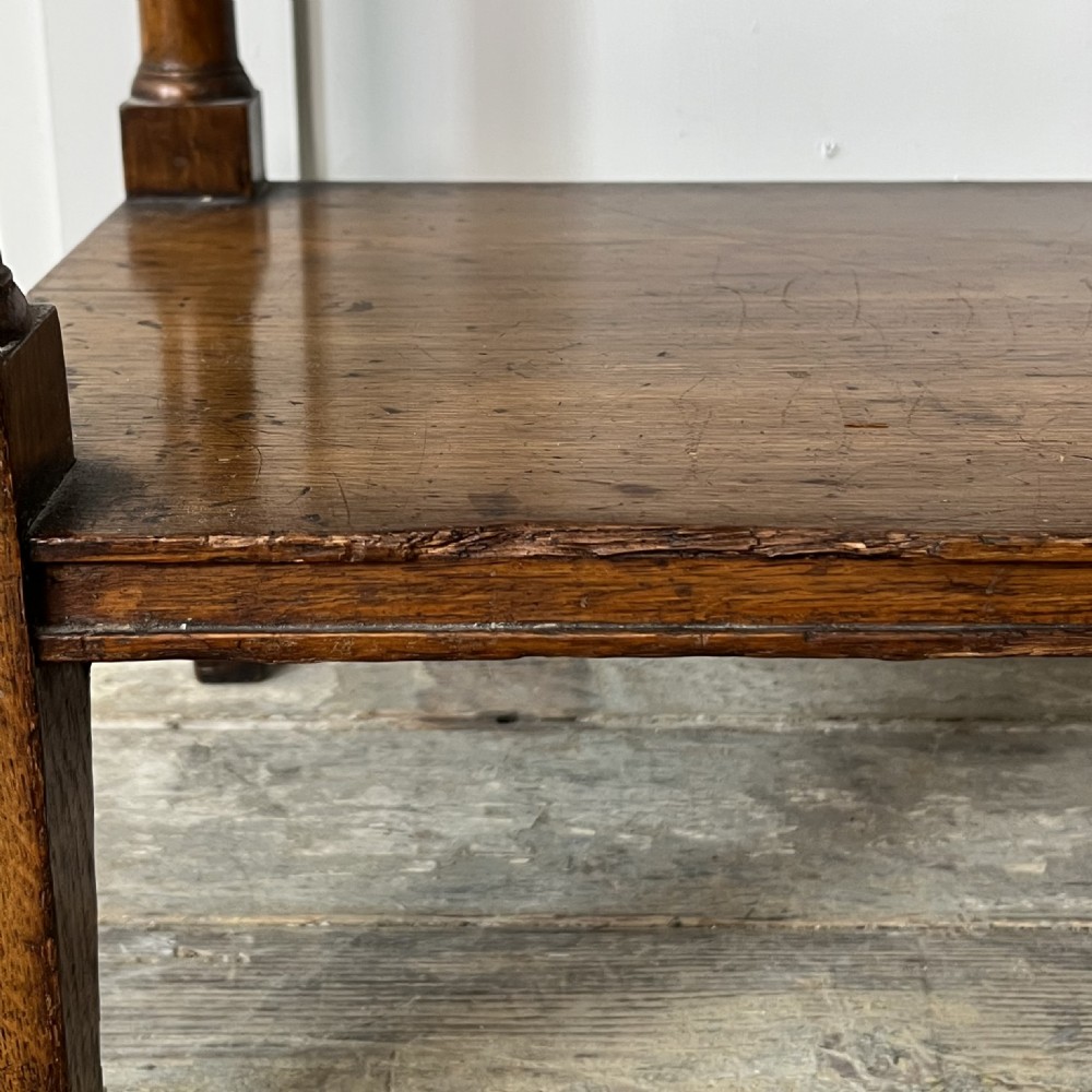 A pair of Victorian oak serving tables featuring tiered shelves, turned upright supports, and two frieze drawers with brass handles. View VII