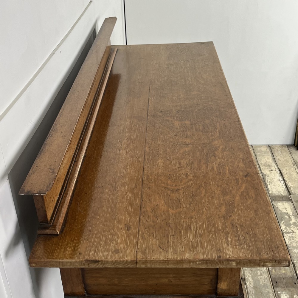 A pair of Victorian oak serving tables featuring tiered shelves, turned upright supports, and two frieze drawers with brass handles. View IX