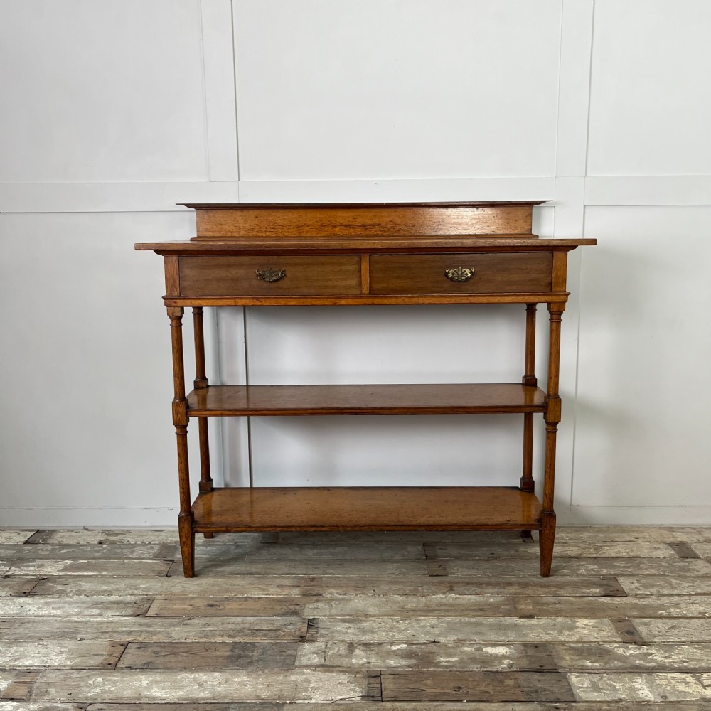 A pair of Victorian oak serving tables featuring tiered shelves, turned upright supports, and two frieze drawers with brass handles. View XI