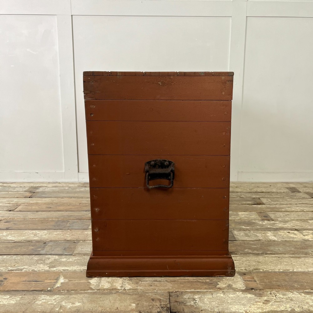 A rectangular reddish-brown painted pine storage chest featuring white hand-painted agricultural typography on the front panel. View X