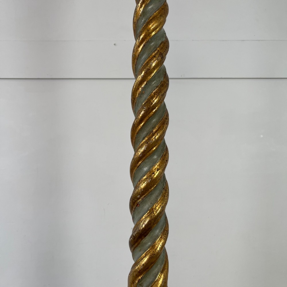 A tall 19th-century Italian carved giltwood and polychrome painted floor candlestick featuring a spiral column shaft resting on a tripod scroll base. View V
