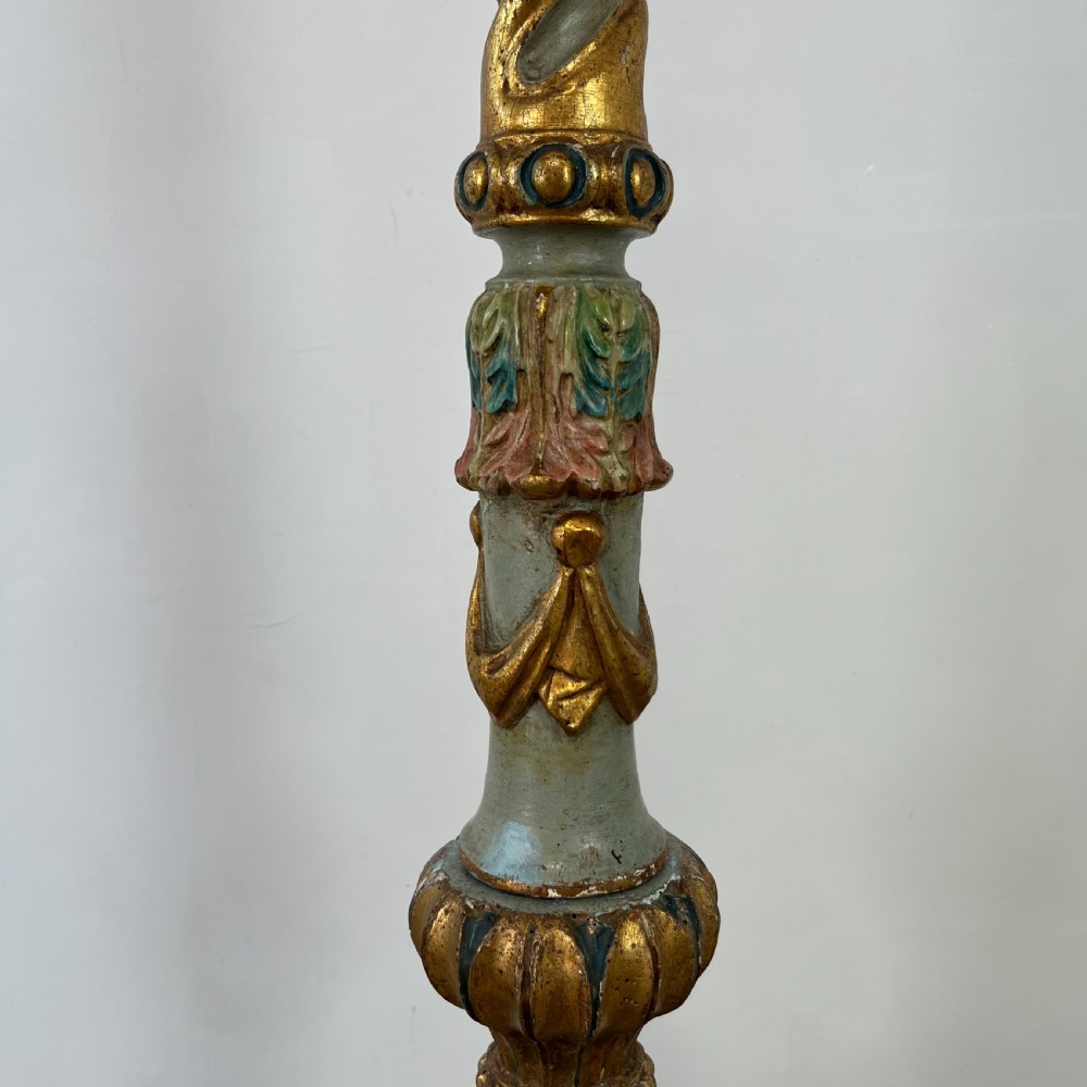 A tall 19th-century Italian carved giltwood and polychrome painted floor candlestick featuring a spiral column shaft resting on a tripod scroll base. View VI