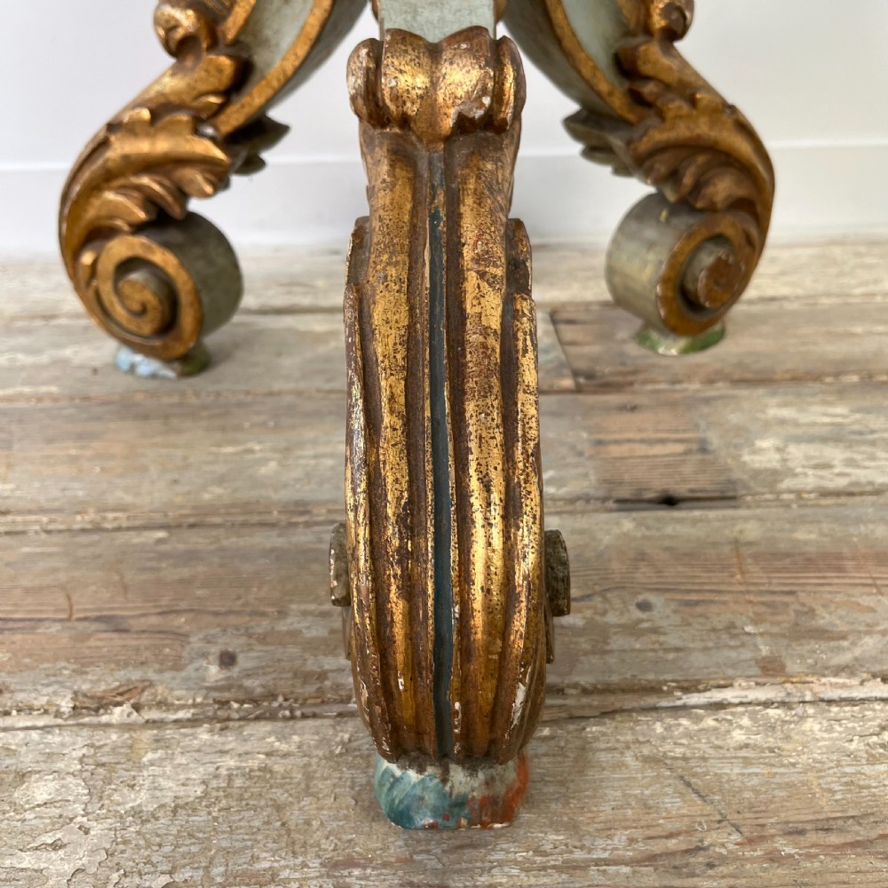 A tall 19th-century Italian carved giltwood and polychrome painted floor candlestick featuring a spiral column shaft resting on a tripod scroll base. View X