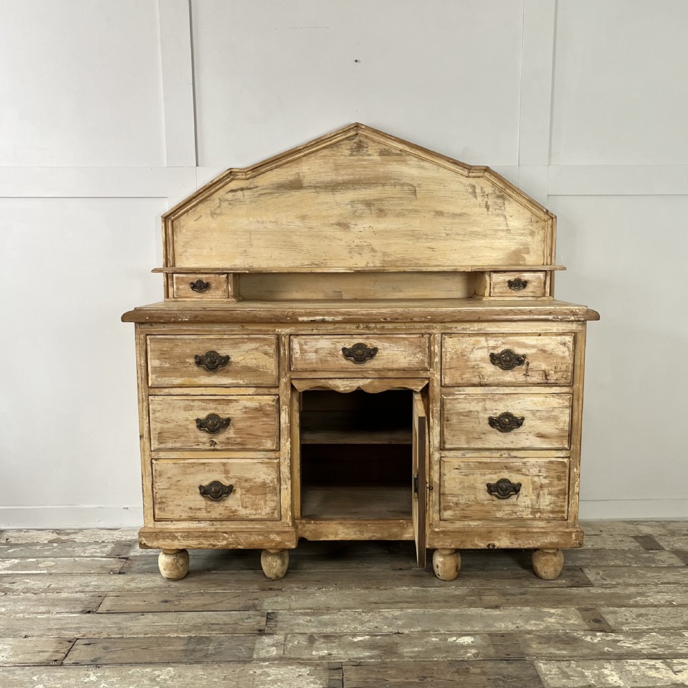 Victorian painted pine dresser with a shaped architectural backboard, multiple drawers, central cupboard, and bun feet in a distressed finish. View II