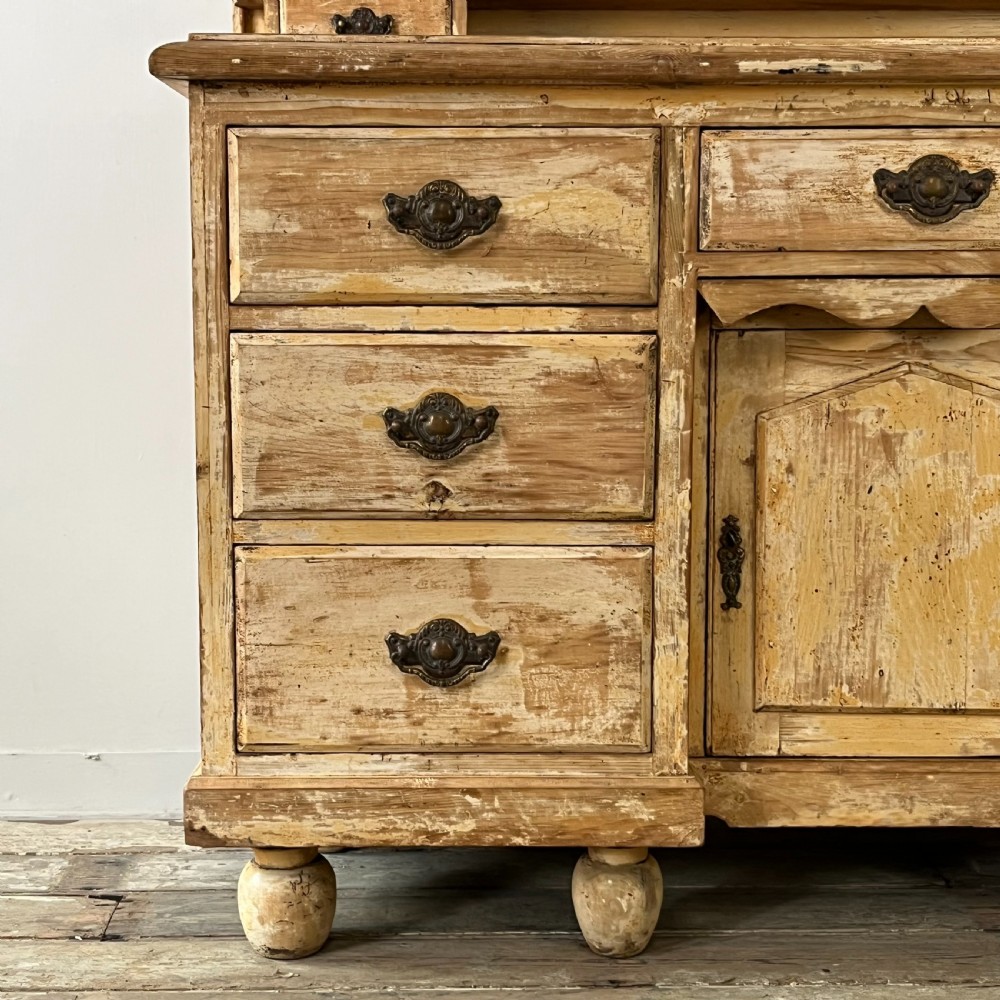 Victorian painted pine dresser with a shaped architectural backboard, multiple drawers, central cupboard, and bun feet in a distressed finish. View III