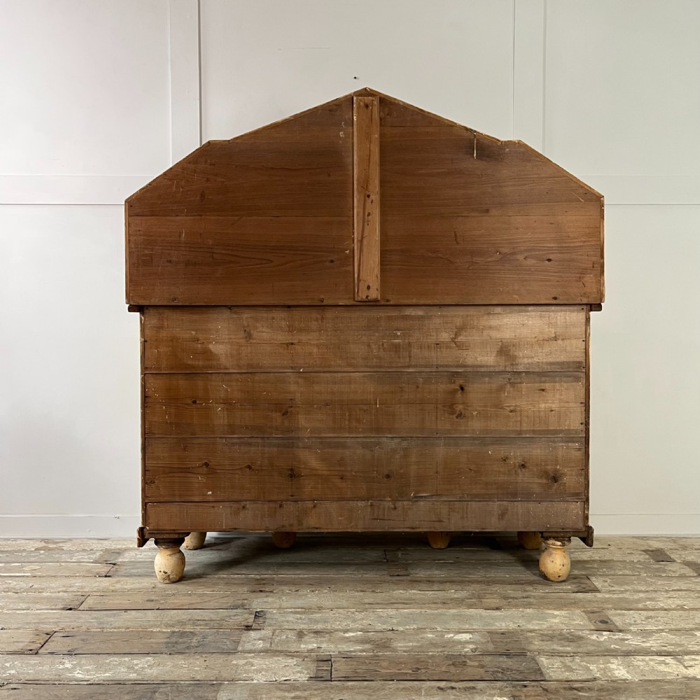 Victorian painted pine dresser with a shaped architectural backboard, multiple drawers, central cupboard, and bun feet in a distressed finish. View XI