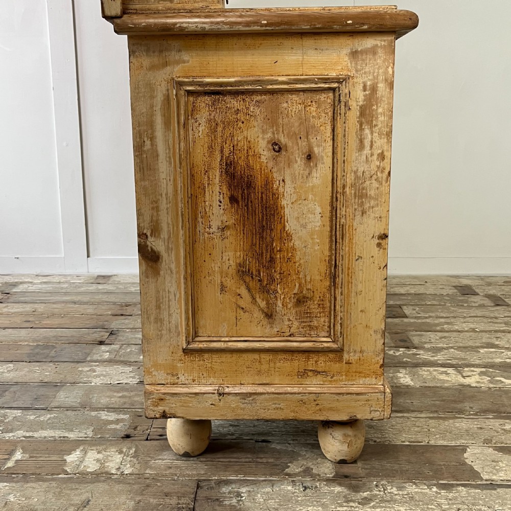 Victorian painted pine dresser with a shaped architectural backboard, multiple drawers, central cupboard, and bun feet in a distressed finish. View XII