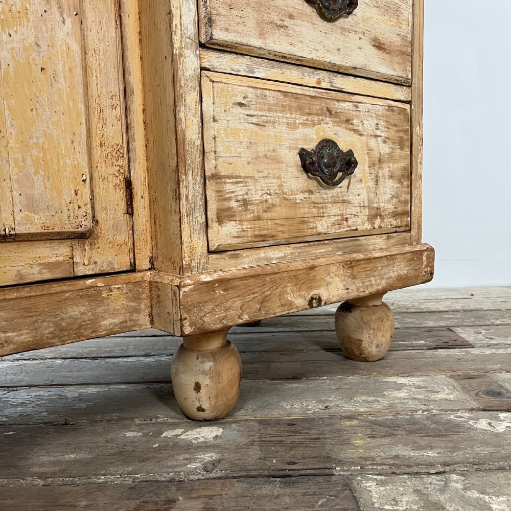 Victorian painted pine dresser with a shaped architectural backboard, multiple drawers, central cupboard, and bun feet in a distressed finish. View XIV