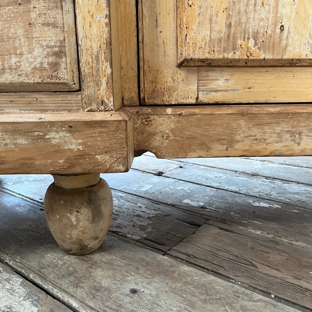 Victorian painted pine dresser with a shaped architectural backboard, multiple drawers, central cupboard, and bun feet in a distressed finish. View XV