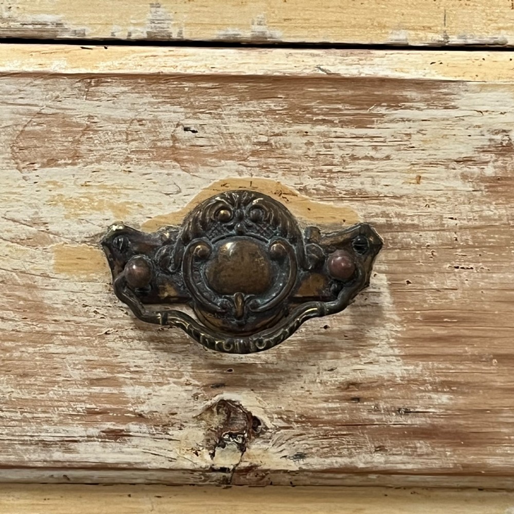 Victorian painted pine dresser with a shaped architectural backboard, multiple drawers, central cupboard, and bun feet in a distressed finish. View XVI