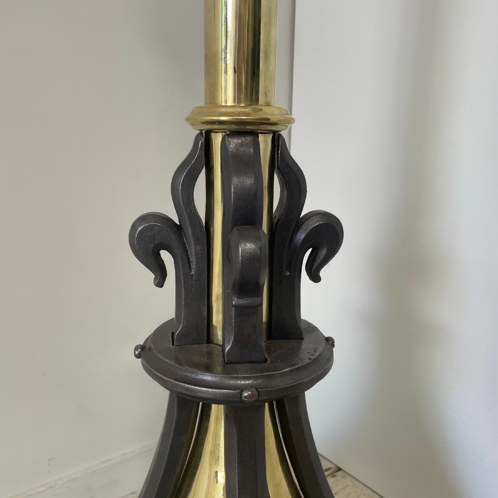 A tall 19th-century Gothic Revival floor-standing church candlestick with a spiral-twist brass column and a dark metal flared base. View V