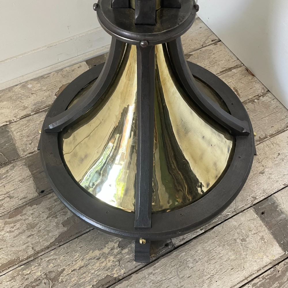 A tall 19th-century Gothic Revival floor-standing church candlestick with a spiral-twist brass column and a dark metal flared base. View VI