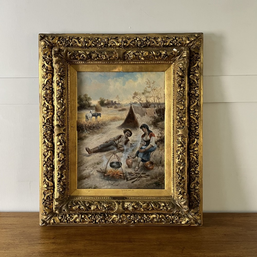 A pair of matching 19th-century oil paintings on board depicting rural peasant scenes in ornate carved gold gilt frames. View II