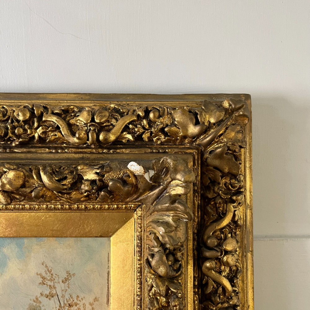 A pair of matching 19th-century oil paintings on board depicting rural peasant scenes in ornate carved gold gilt frames. View IX