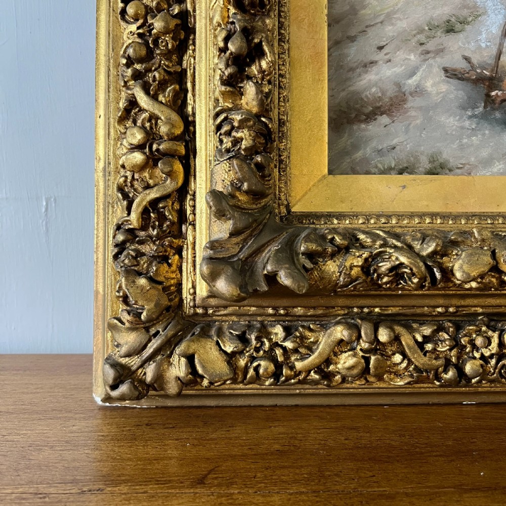 A pair of matching 19th-century oil paintings on board depicting rural peasant scenes in ornate carved gold gilt frames. View X