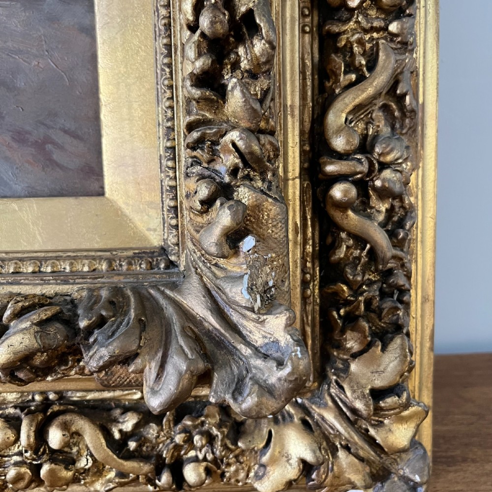 A pair of matching 19th-century oil paintings on board depicting rural peasant scenes in ornate carved gold gilt frames. View XIX