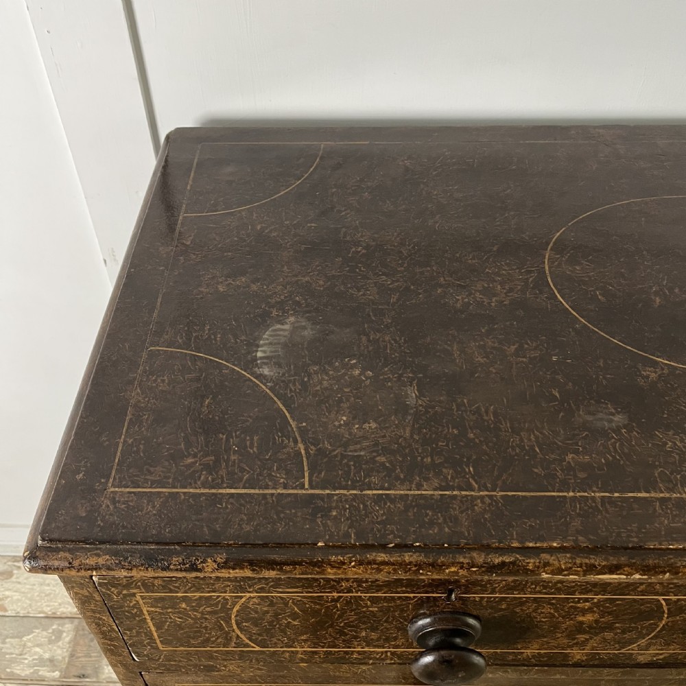 A nineteenth-century scumble-painted pine chest of drawers with decorative faux inlay lines, dark turned handles, and ball feet. View IX
