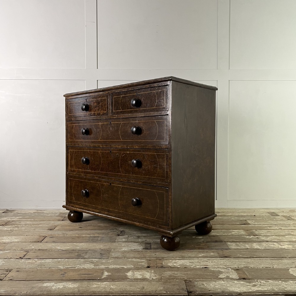 A nineteenth-century scumble-painted pine chest of drawers with decorative faux inlay lines, dark turned handles, and ball feet. View XV