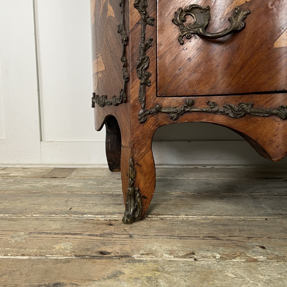 A nineteenth-century French rosewood commode featuring intricate floral marquetry, gilt-bronze mounts, three drawers, and a shaped marble top. View III