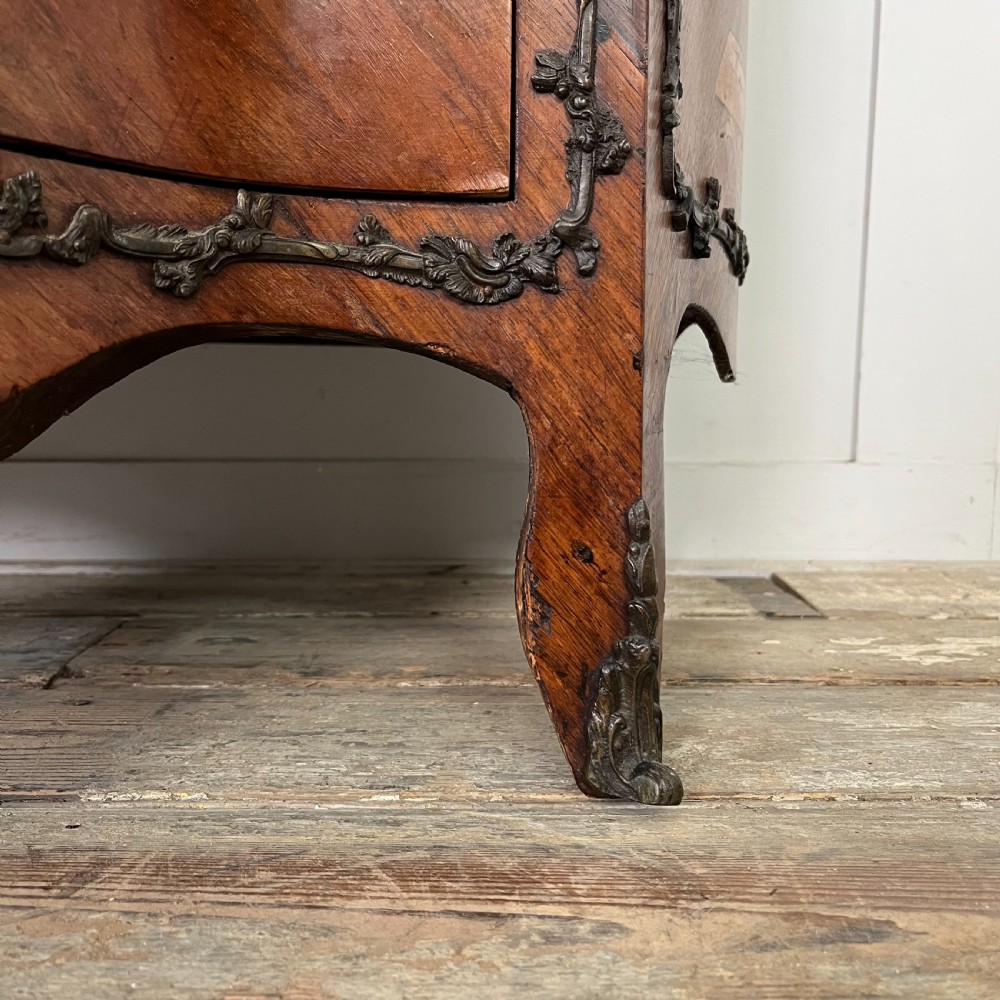 A nineteenth-century French rosewood commode featuring intricate floral marquetry, gilt-bronze mounts, three drawers, and a shaped marble top. View IV