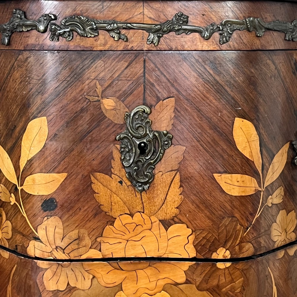 A nineteenth-century French rosewood commode featuring intricate floral marquetry, gilt-bronze mounts, three drawers, and a shaped marble top. View VI