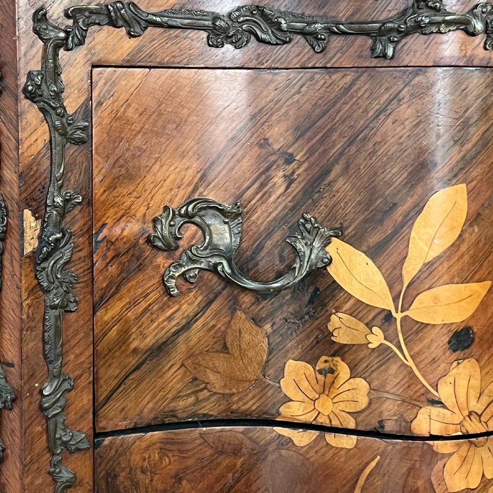 A nineteenth-century French rosewood commode featuring intricate floral marquetry, gilt-bronze mounts, three drawers, and a shaped marble top. View VII