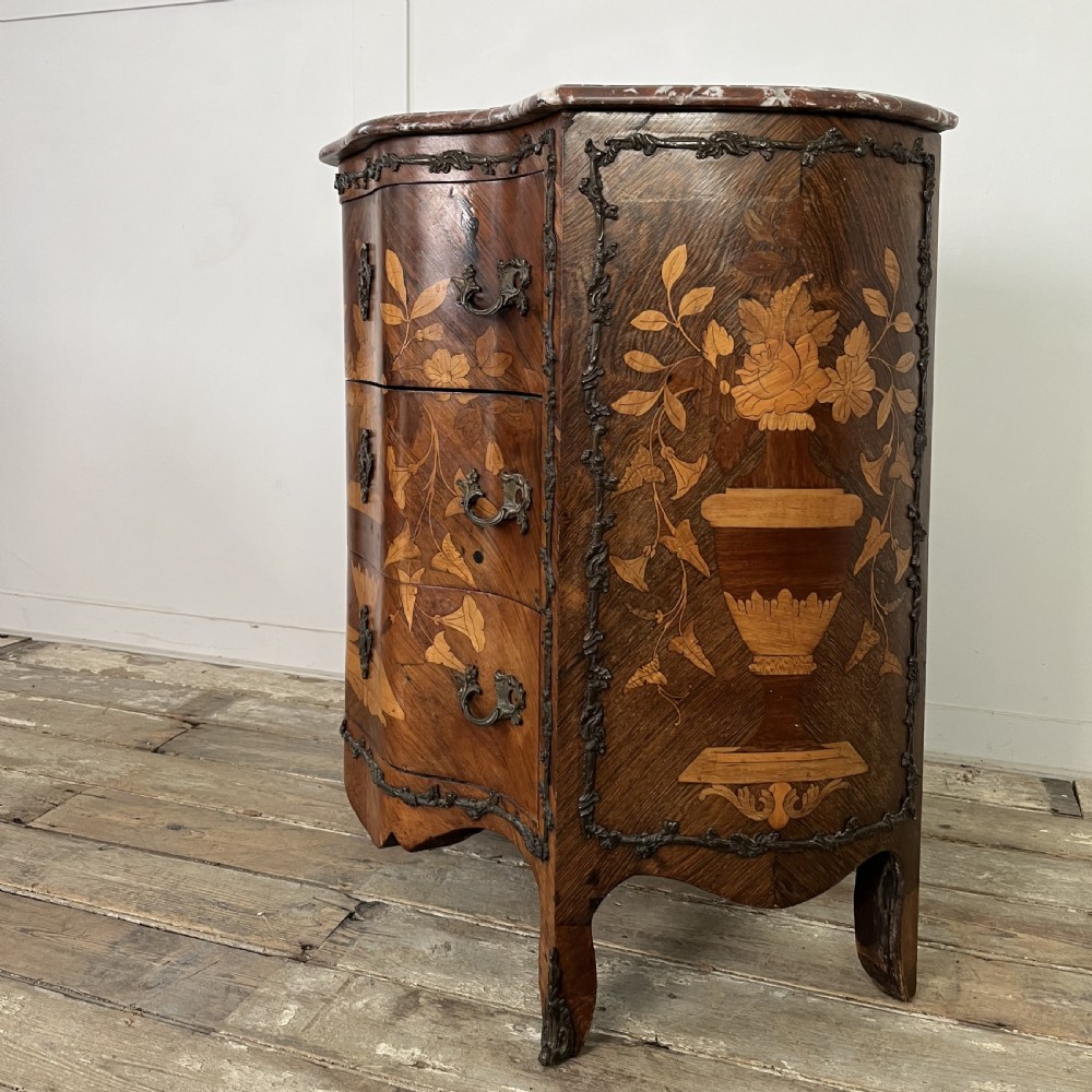 A nineteenth-century French rosewood commode featuring intricate floral marquetry, gilt-bronze mounts, three drawers, and a shaped marble top. View XI
